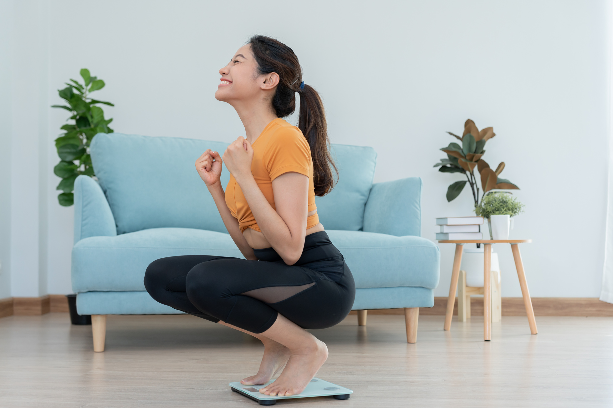 asian women happy results of diet. Beautiful shape. female have a reduced waist size after under going a weight loss corse. can not wear jean due to weight loss. balance, control, routines, exercise.